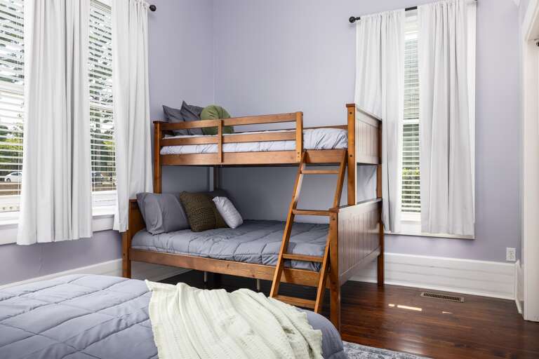 Experience rustic charm and functionality in the bedroom with a beautiful wooden bunk bed, adding a touch of natural elegance to your stay. Plenty of room to accommodate all guests, with a queen bed on the bottom and twin bed on the top. 
