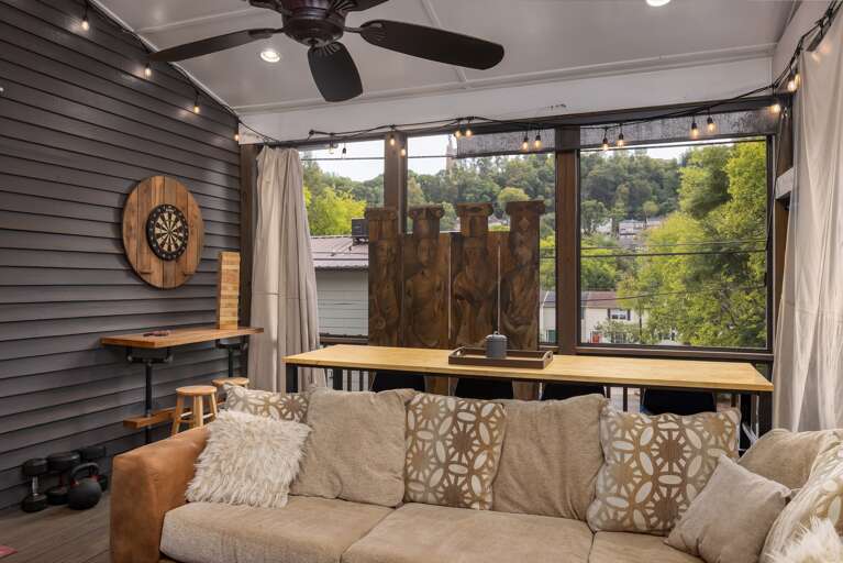Relax on the cozy sectional of our screened-in porch, the perfect spot to unwind and enjoy the outdoors. Relax on the cozy sectional of our screened-in porch, the perfect spot to unwind and enjoy the outdoors.