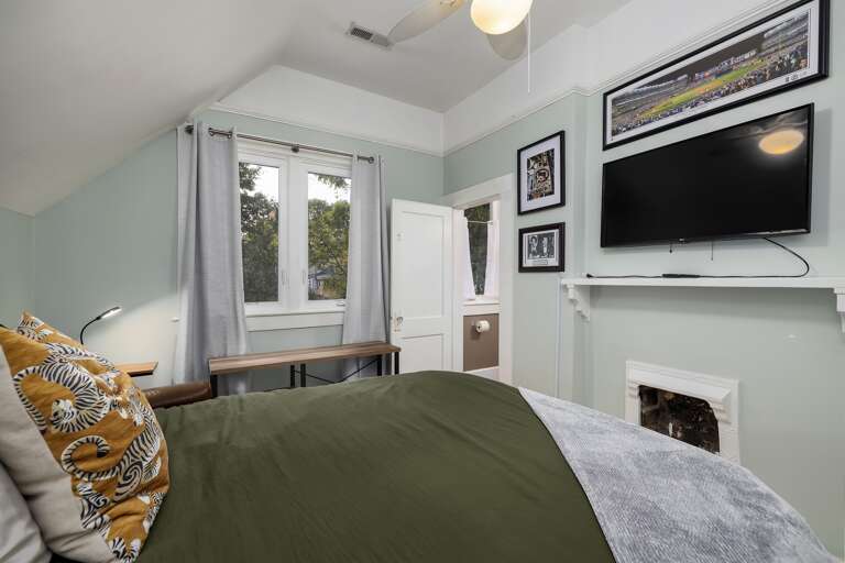 Our second upstairs bedroom offers a comfortable queen bed and a flat-screen TV for your enjoyment. Our second upstairs bedroom offers a comfortable queen bed and a flat-screen TV for your enjoyment.