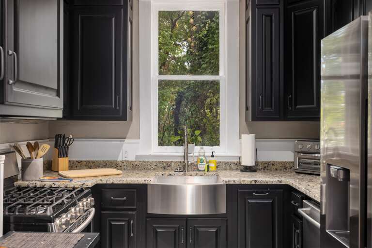 Conveniently tackle dishes in our kitchen's large stainless steel sink. Conveniently tackle dishes in our kitchen's large stainless steel sink.