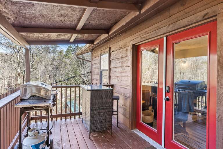 Stepping into relaxation and adventure at our cabin retreat. Enjoy a cozy porch with a BBQ grill, we even have BBQ grill utensils for you to use!