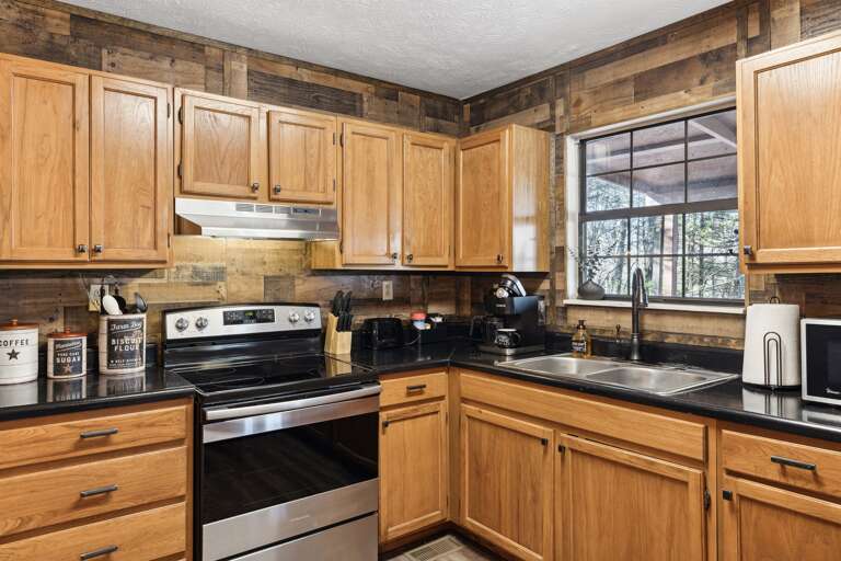 Fully equipped kitchen with plates, bowls, silverware, pots and pans, cutting boards, knives, a crock pot and so much more!