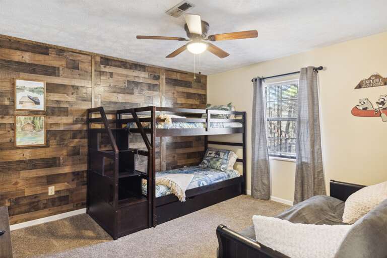 A cozy haven for little ones: Our kids' room with a bunk bed, trundle, and a comfy futon.