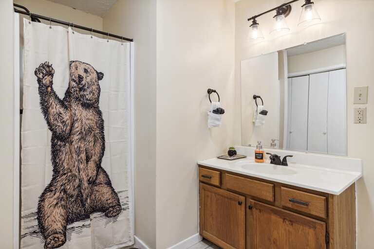 Third bathroom, located downstairs, next to the kids room, game room, and second king suite