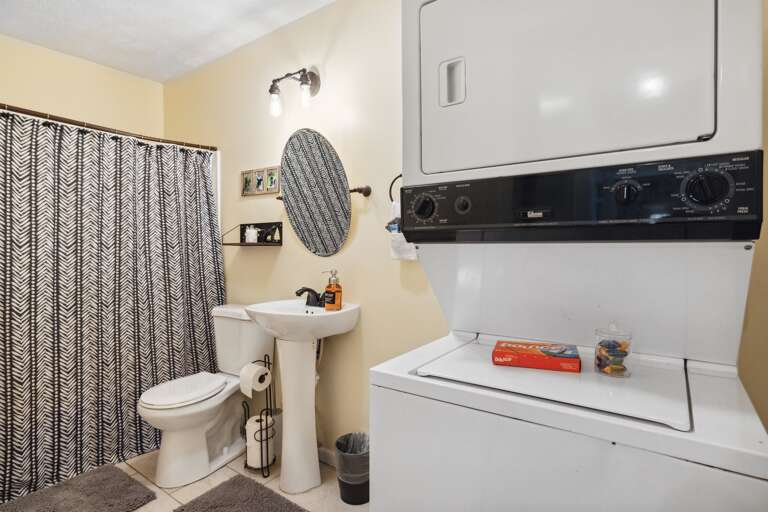 Maximizing space and convenience: our bathroom with a tub/shower combo and added bonus of a washer/dryer.