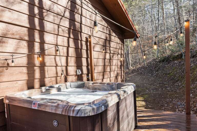 Unwind and bask in the soothing glow of the hot tub and cafe lights.