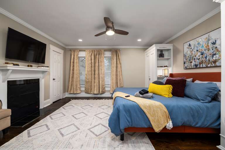 Retreat to the king bedroom, a haven of rest offering a plush king-sized bed, elegantly appointed decor, and a private TV for leisurely viewing, creating a perfect escape for relaxation and rejuvenation.