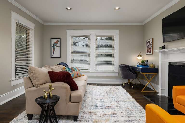 Welcome Home: A cozy living room awaits with plush seating and warm lighting, perfect for relaxation after a day of exploring. 