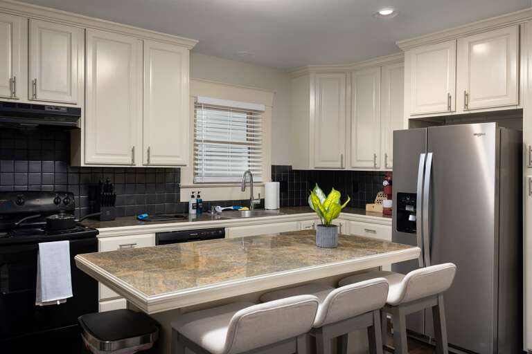 Savor your meals at our inviting kitchen bar dining space, designed for both style and comfort, where you can enjoy casual dining, morning coffees, or simply socialize over a quick bite.