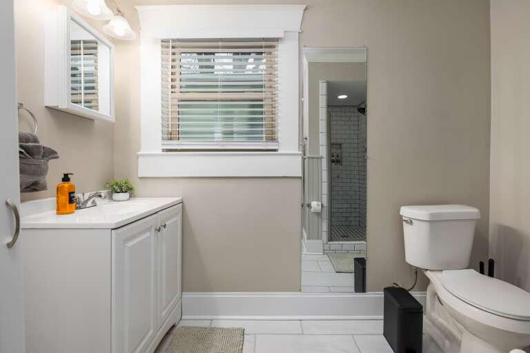Refresh and prepare for your day in our well-appointed bathroom, complete with a full-length mirror to ensure you look your best, harmonizing convenience with a touch of elegance.