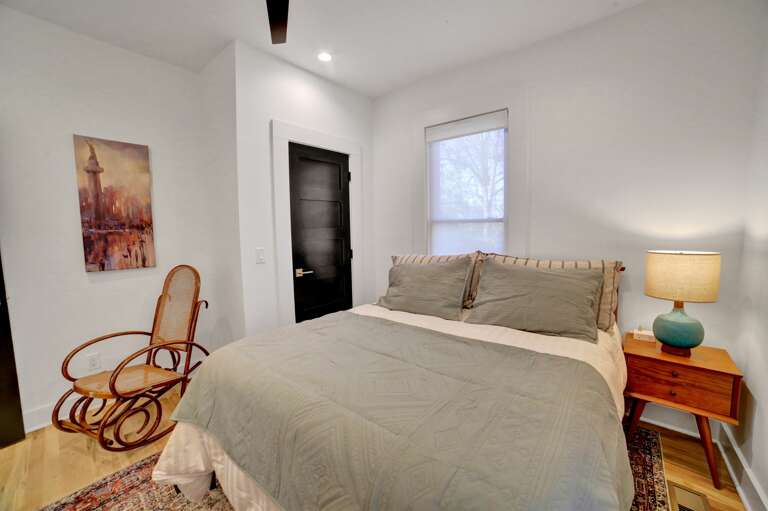 **Second Queen Bedroom Cozy**: Featuring a soothing rocking chair, this bedroom offers a peaceful haven for relaxation.