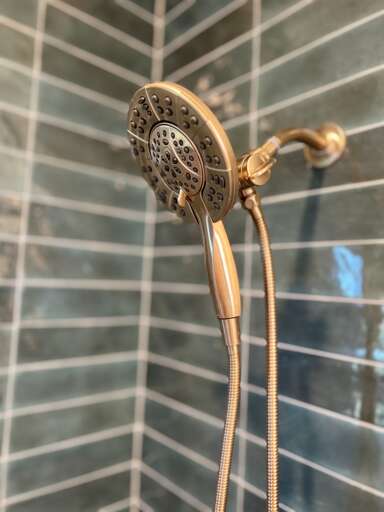 **Shower Elegance**: The detachable showerhead, highlighted in this photo, adds a touch of luxury and convenience to the bathroom.