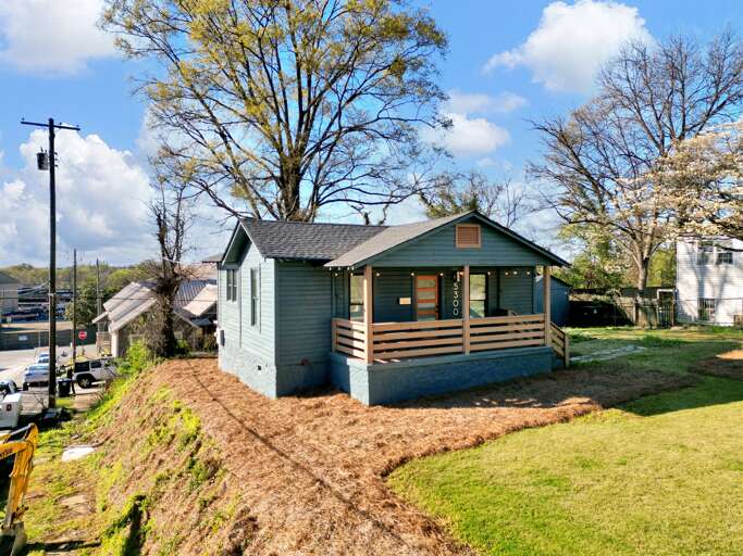 Behold the allure of Crestwood Bliss Bungalow from the outside, where a lush green lawn sets the stage for a cozy and inviting front porch. This picture-perfect setting not only promises a warm welcome but hints at the lovingly maintained oasis within.