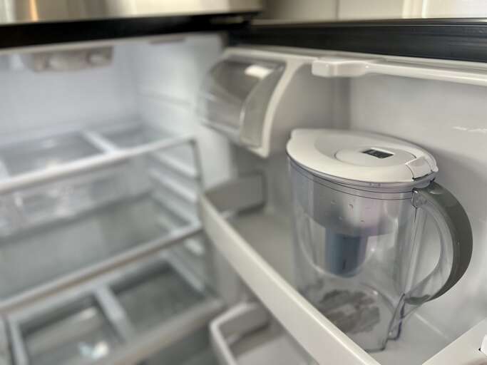 **Fridge Features**: Inside the fridge, the water filter exemplifies the thoughtful amenities offered in this well-appointed kitchen.