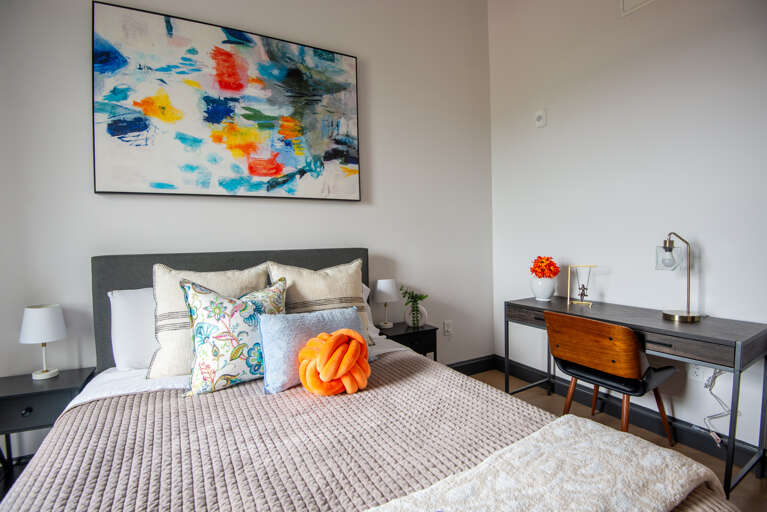 Our bedroom doubles as a productive workspace, featuring a comfortable bed and a dedicated area for when inspiration strikes.