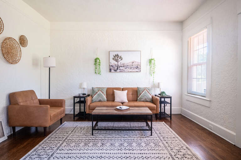 Sink into the comfort of our living room, adorned with plush brown leather seating, designed for your ultimate relaxation and enjoyment.