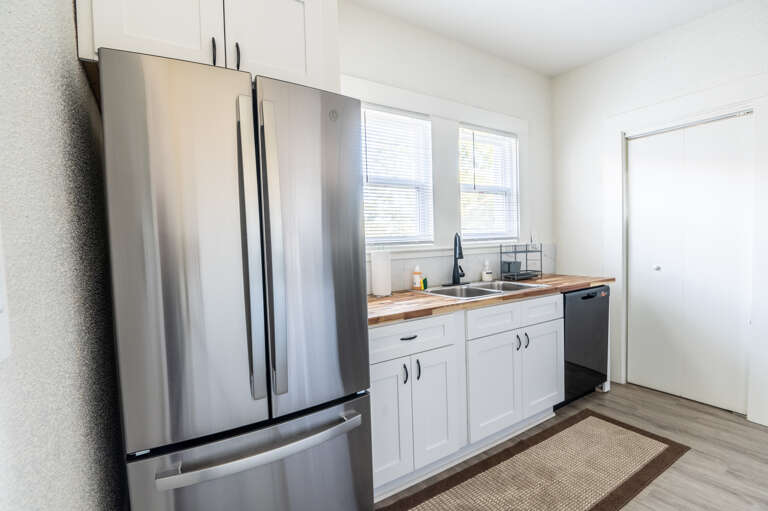 Culinary dreams come alive in our fully equipped kitchen, boasting a stainless steel fridge and everything you need to whip up delicious memories.