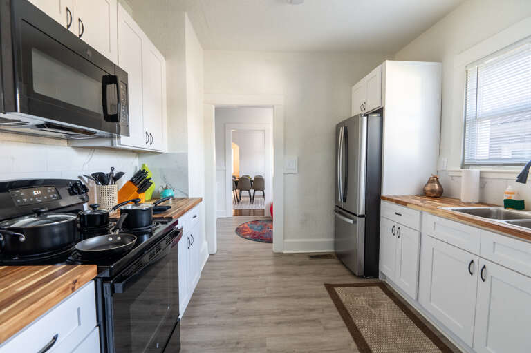 Culinary adventures await in our kitchen, stocked with pots, pans, and knives—everything you need for a gourmet meal.