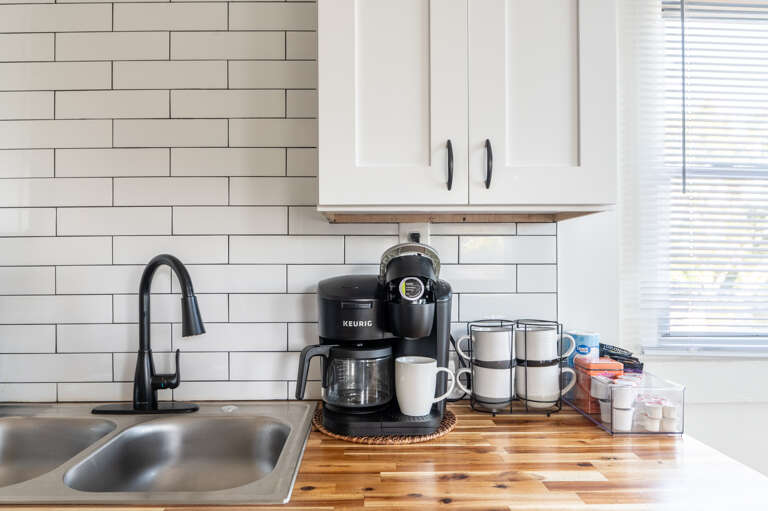 Your morning coffee, ready at your fingertips with our coffee maker and stainless steel sink. 