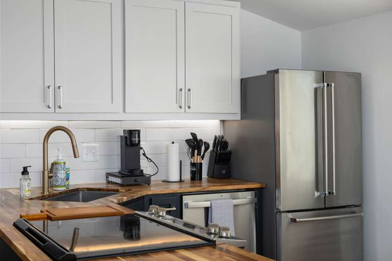 Featuring high-end amenities like a sleek fridge, efficient dishwasher, convenient Keurig, and a modern garbage disposal, this kitchen blends utility with luxury.