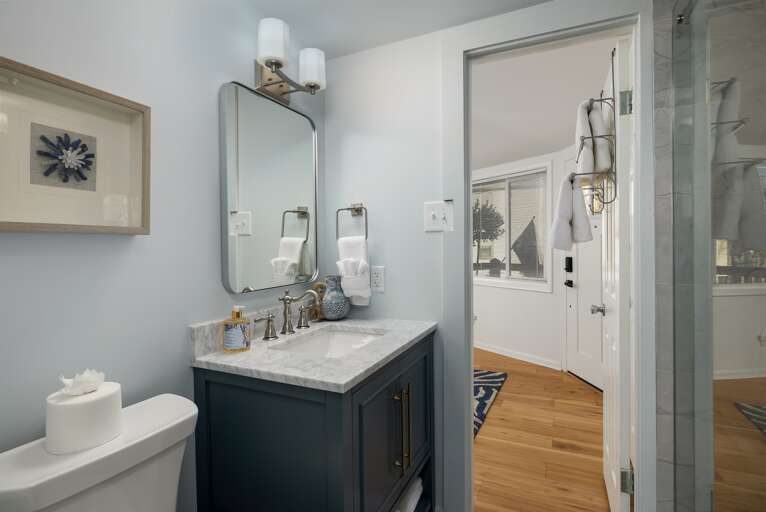 Step into luxurious comfort in a bathroom designed with fine marble, where fresh white linens and quality toiletries await to pamper you.