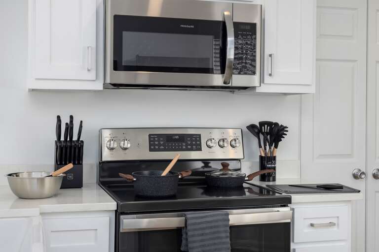 Step into a kitchen that awaits your culinary flair, fully prepped for you to whip up your favorite meal during your unforgettable stay.