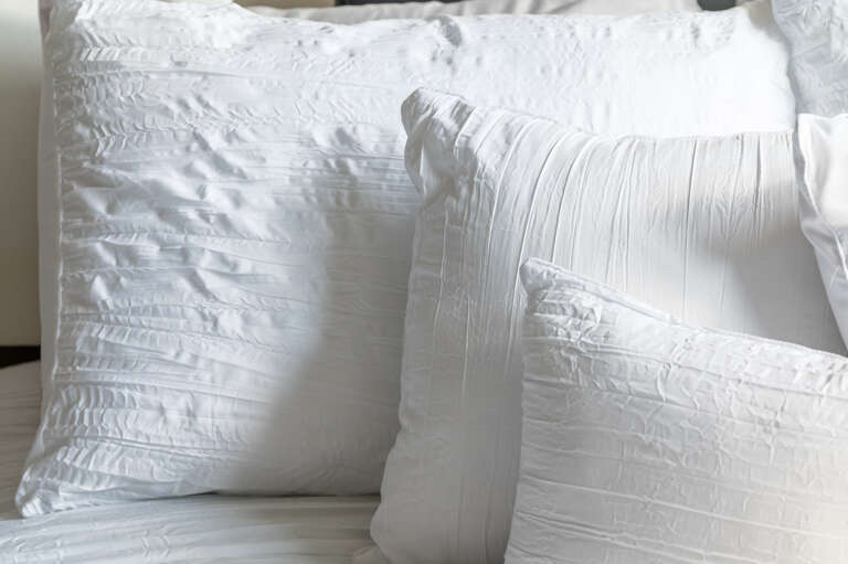 Detail shot of the crisp white pillows in the second bedroom.