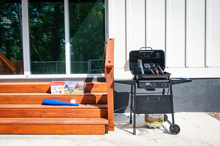 Outdoor space with grill and utensils perfect for BBQs. Grill, relax, and explore with Legacy Stays!