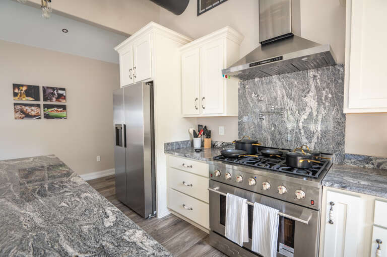 Fully equipped kitchen with utensils, pots, pans, and a convenient pot filler.