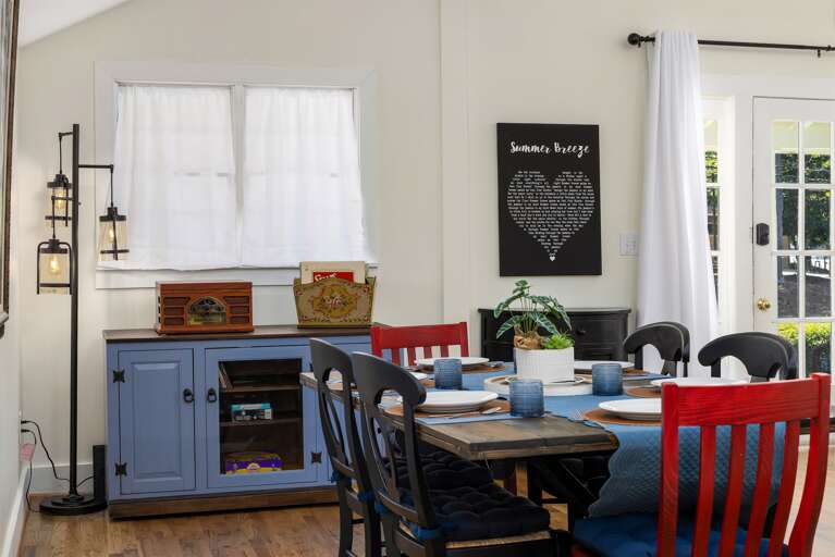 This corner of the dining area features a vintage record player and a canvas displaying the lyrics of the song "Summer Breeze." It's a delightful touch that adds character and a personal connection to the home's name.