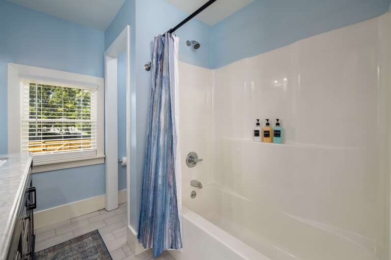 The bathroom offers a spacious layout and stylish fixtures, ensuring guests have a comfortable and pleasant experience.