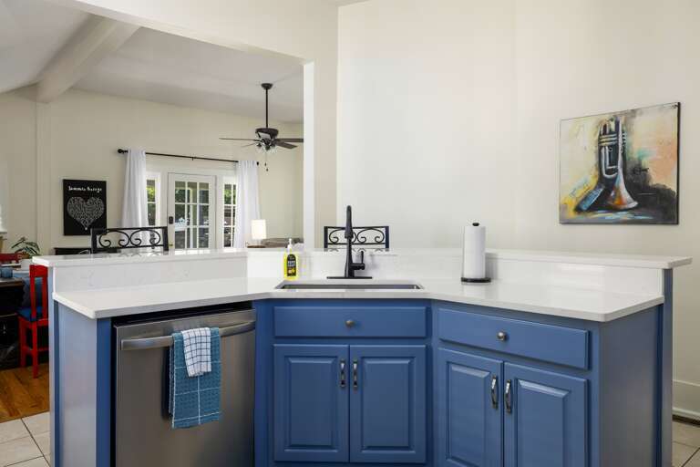 Another view of the fully equipped kitchen showcases its modern design, complete with all necessary appliances, ample storage, and beautiful countertops.