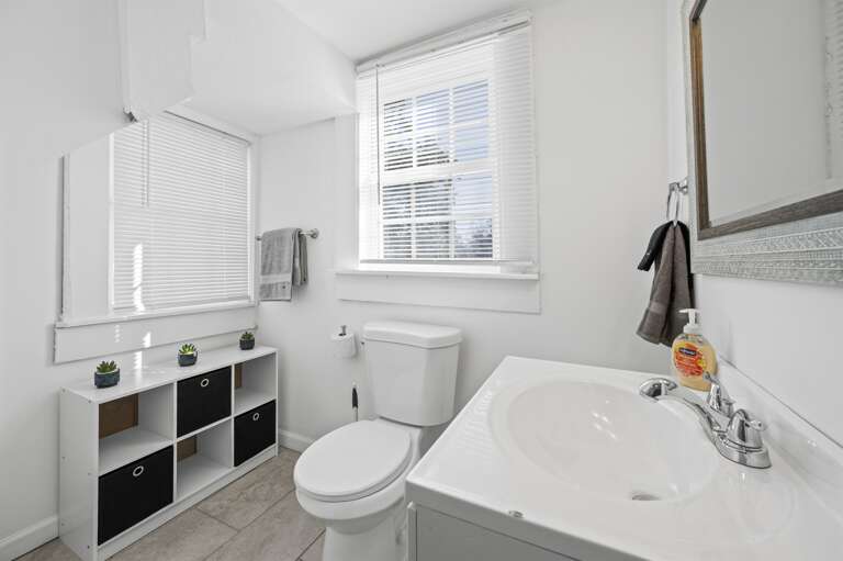 Half bath equipped with towels and toilet paper, ensuring comfort for your stay.