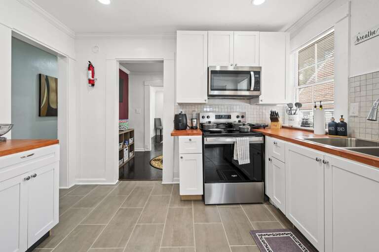 Fully equipped kitchen with stove, oven, microwave, and air fryer for all your culinary needs.