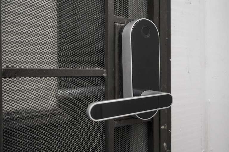 Secure metal door with an auto-locking smart lock for added peace of mind.