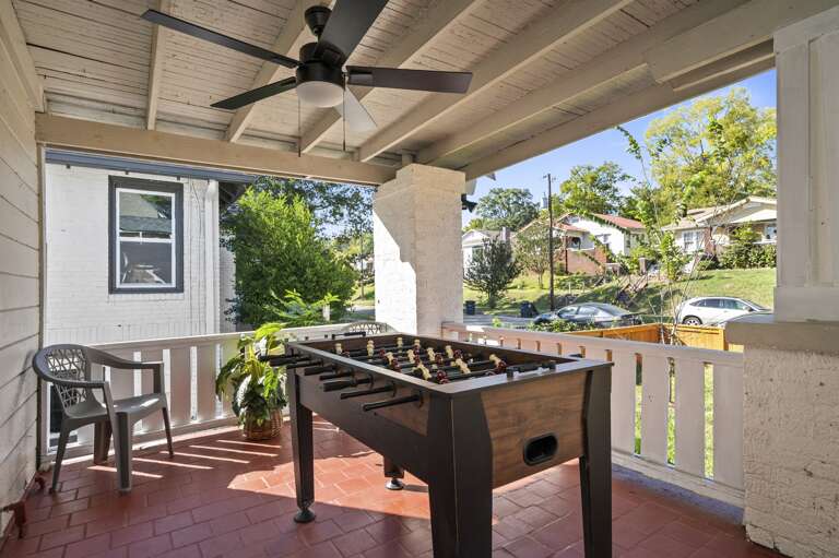 Unit A's front patio features a metal door lock, foosball table, and comfortable seating