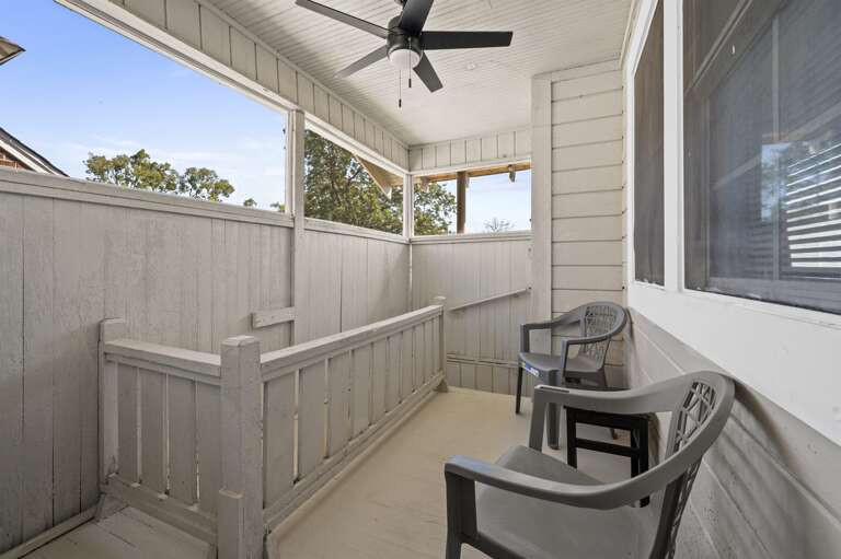 Spacious back patio, ideal for enjoying the outdoors in a comfortable screened-in setting.