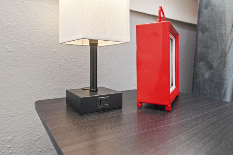 Double full bedroom with lamps featuring charging ports, offering convenience for guests.