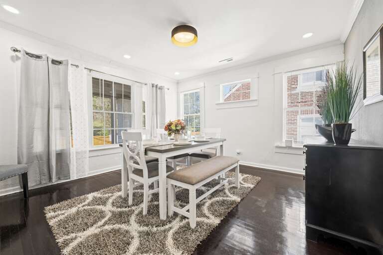 Elegant dining room with seating for six, including a cozy bench, perfect for meals. Elegant dining room with seating for six, including a cozy bench, perfect for meals.