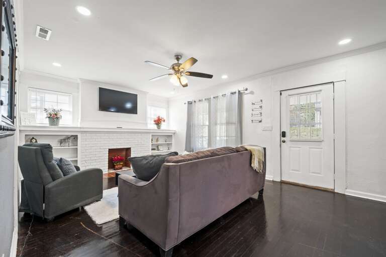 Relax in the stylish living room featuring a gray sectional, massage chair, and large smart TV. Relax in the stylish living room featuring a gray sectional, massage chair, and large smart TV.