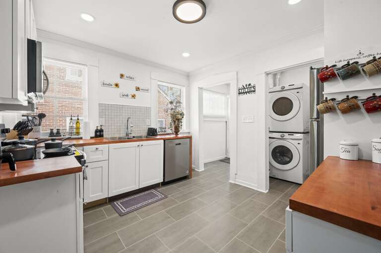 Kitchen seamlessly leads to a fully equipped laundry room and a screened-in back patio. Kitchen seamlessly leads to a fully equipped laundry room and a screened-in back patio.