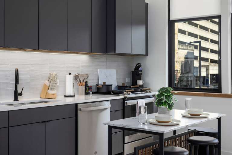 Your fully equipped kitchen awaits! Featuring a sleek design, stainless steel appliances, and a cozy breakfast bar for two, it's perfect for morning coffee or evening drinks in the comfort of your home away from home.