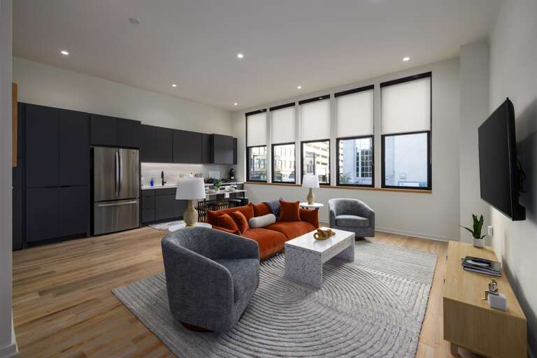 Relax in a vibrant living area that seamlessly transitions into the kitchen, creating a spacious and inviting environment for dining, entertainment, or unwinding.