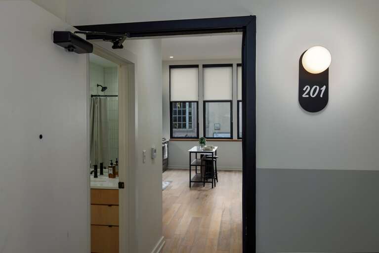 Step into luxury and charm—your private retreat on historic 2nd Avenue North, featuring a sleek modern entryway that opens up to the beautifully designed interior of this condo.