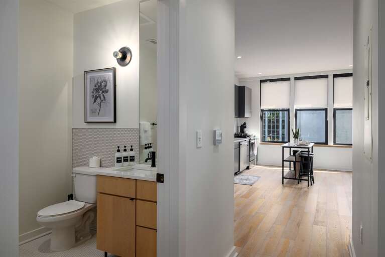 A well-thought-out space—this modern bathroom and kitchen setup offers both convenience and style, with seamless transitions between areas, making your stay comfortable and functional.