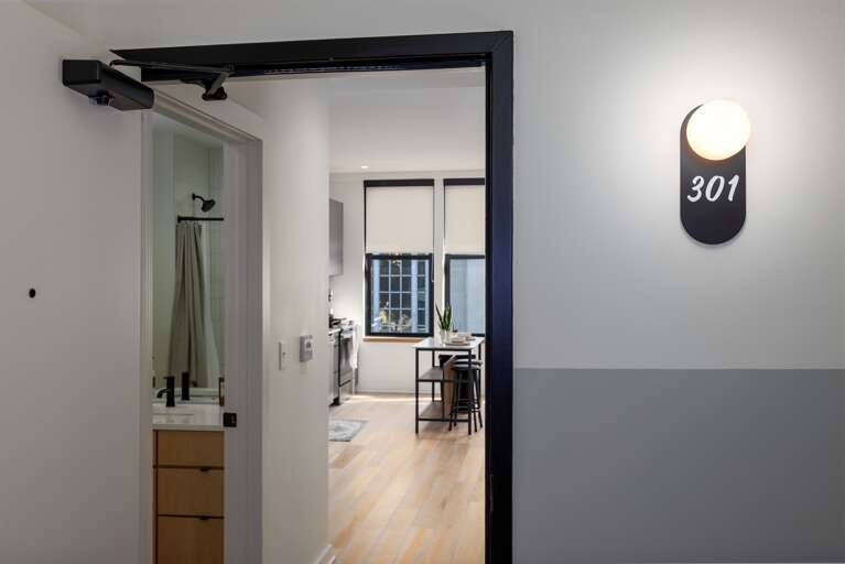 Step into luxury and charm—your private retreat on historic 2nd Avenue North, featuring a sleek modern entryway that opens up to the beautifully designed interior of this condo.