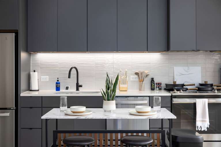 Dine in comfort—this marble-topped kitchen island with seating for two is the perfect spot for casual dining or sipping a drink while taking in the city views.