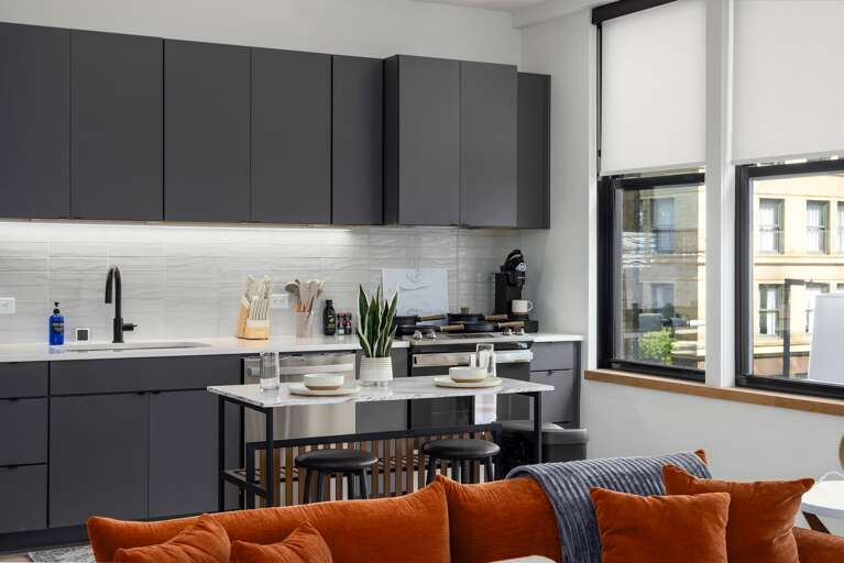 Open and inviting—this open-concept kitchen and living room offer the perfect balance of luxury and coziness, making it easy to enjoy cooking and relaxation in the same space.