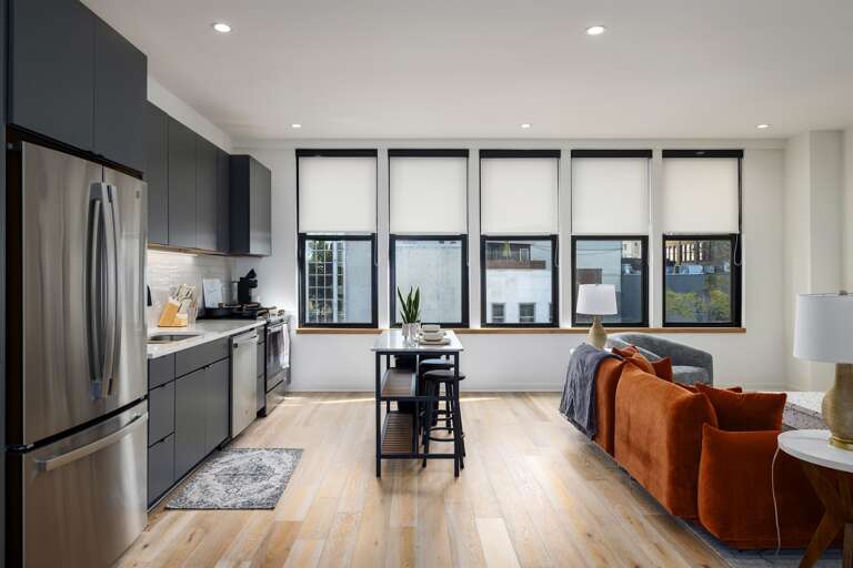 Relax and unwind—this inviting living room is designed for comfort, with vibrant decor, cozy seating, and a large TV for all your entertainment needs.