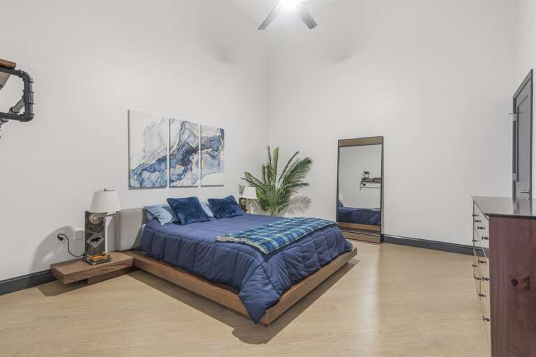 The bedroom from another perspective, showing a glimpse of the living area through the doorway, illustrates the cohesive flow of the apartment’s design and its inviting ambiance. The bedroom from another perspective, showing a glimpse of the living area through the doorway, illustrates the cohesive flow of the apartment’s design and its inviting ambiance.